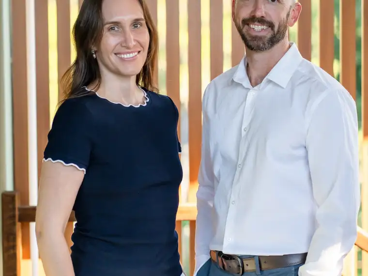 Two Constellation clinicians standing together in front of a timber screen