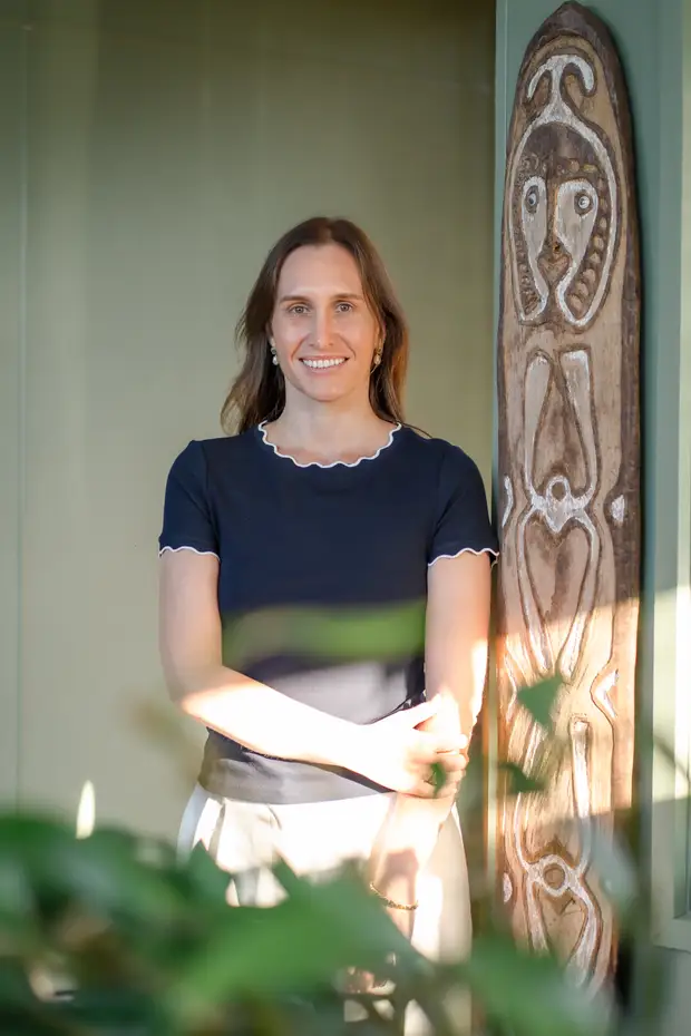 A Constellation Therapies team member smiling in a sunlit doorway