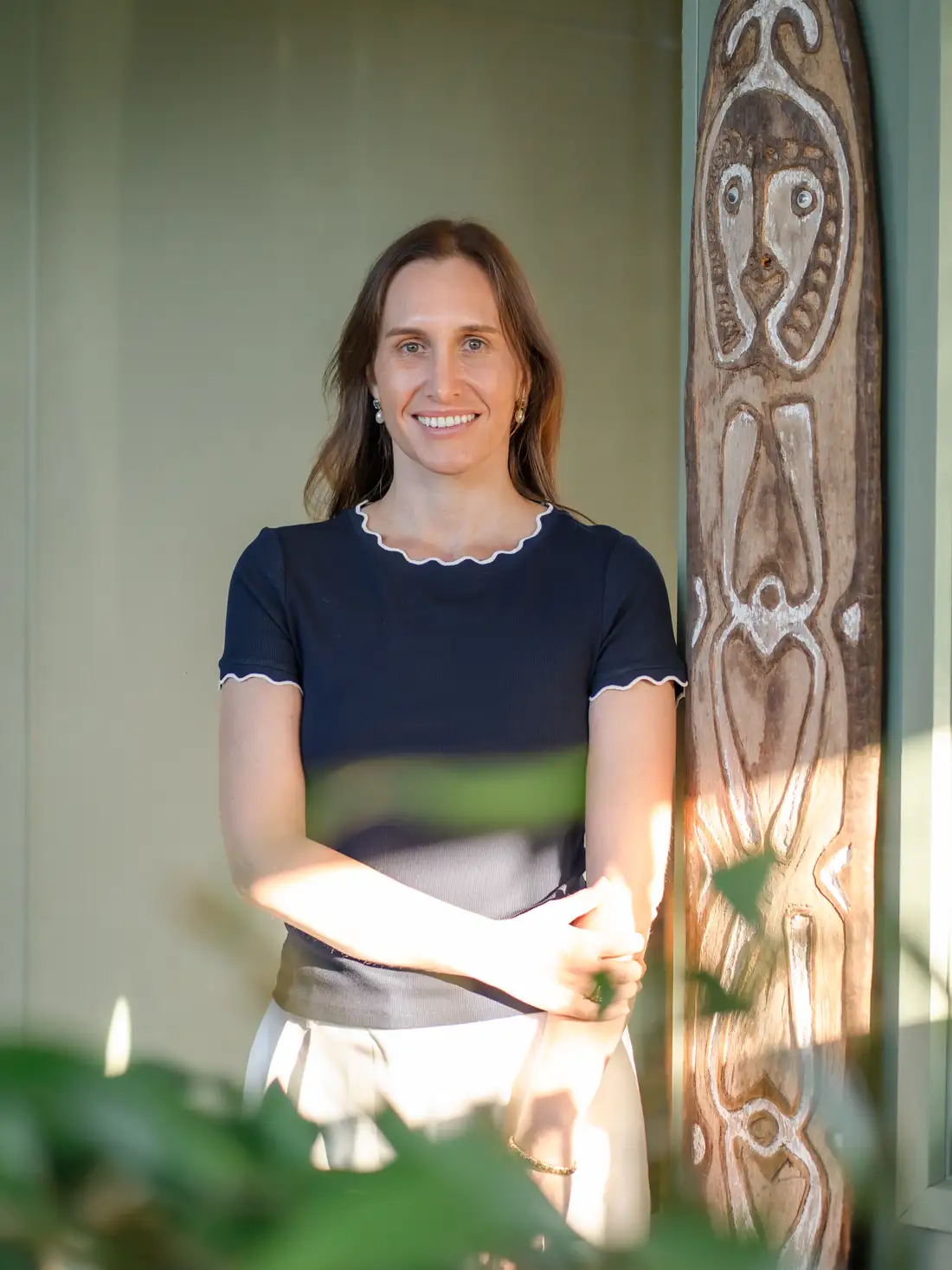 A Constellation Therapies team member smiling in a sunlit doorway