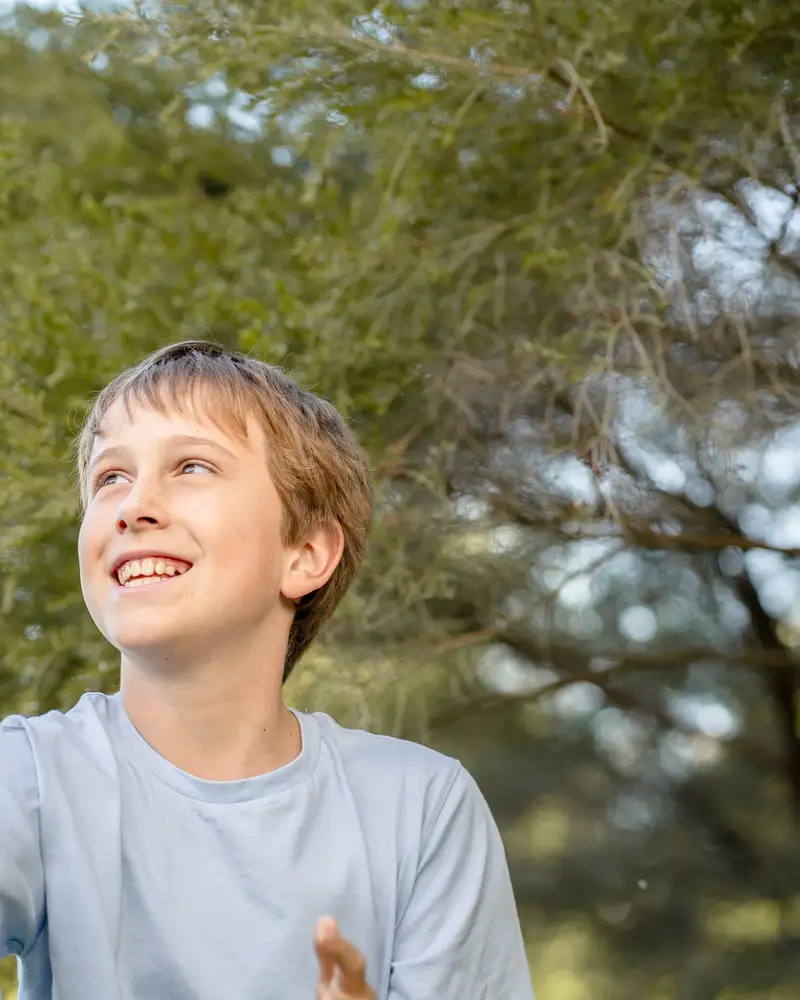 A child playing outdoors in warm afternoon light