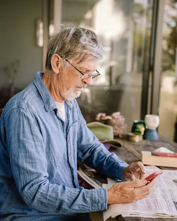 A practitioner reviewing notes and paperwork at a desk